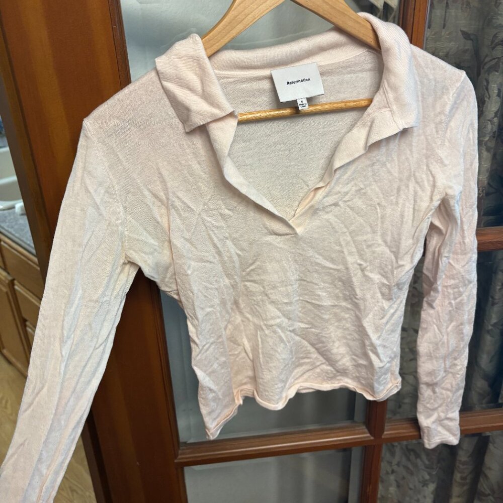 Slightly cropped, ballet pink reformation polo knit sweater